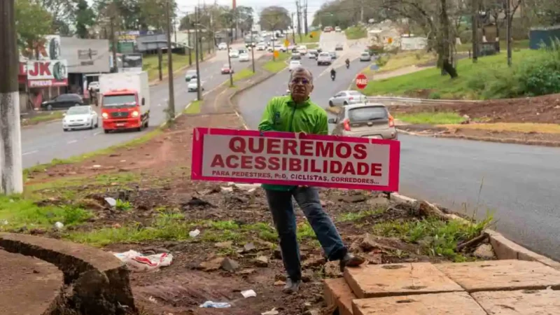 Em protesto por obra parada da JK, ciclista expõe faixa no viaduto em Foz do Iguaçu